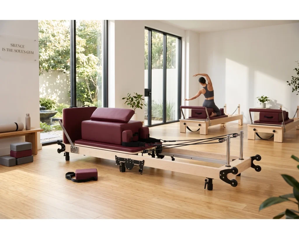 CP207 Maple Folding Reformer in Pilates Studio CP207 maple folding Pilates reformer in a bright commercial studio